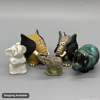 Front view of all five ceramic elephant figurines