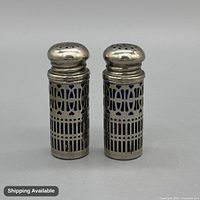 front view of both shakers showing pierced design and blue liners