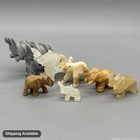 Group view of seven soapstone elephant figurines showing size and colour variations