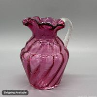 Front view of cranberry glass pitcher