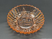 Oblique view of entire bowl showing fruit motif and starburst pattern