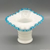 Front angled view showing ruffled aqua crest edge and interior of vase