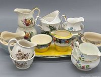 Group shot of all creamers, sugar bowls, gravy boat and trays