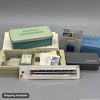 Overall lot showing tins, cases, needle packs, seam gauge