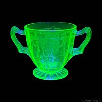 Sugar bowl glowing under UV light showing uranium content