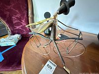 Full view of metal bicycle sculpture on table