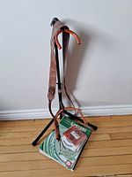 Stand, strap and instruction book on floor