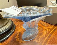 Full view showing flared rim, clear and blue frosted glass, human-figure base