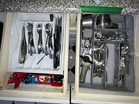 Drawer with all flatware, knives, measuring tools and gadgets visible