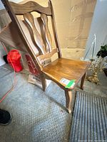 Front side view of wooden dining chair showing seat, backrest, and legs
