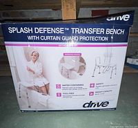 Retail box front displaying Drive Splash Defense Transfer Bench branding and product image