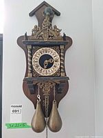 Full view of wall clock showing complete item with weights