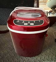 Front view of red Frigidaire portable countertop ice maker