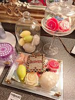 Overall lot with both cloches, mirrored tray, soaps, beads and pillow