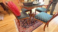 Dining table with glass top and four upholstered chairs