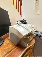 Side view of HP Officejet v40 with control panel and cables on top, tray open