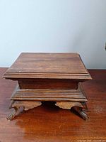 Overall view of wooden keepsake box on carved legs