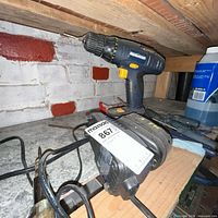 Mastercraft drill positioned upright on shelf with charger and battery visible