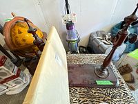 Side view showing wrapped mirror, wooden base, and two turned uprights
