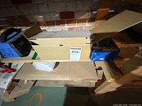 Closed Moen box on shelf with lot label visible