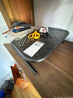 Lap desk with bell, scissors, pens, orange folder visible
