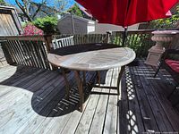 Top view of round wooden table on deck