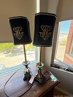 Full view of both lamps on table showing shades, stems, cords