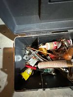 Open toolbox showing hand tools, adhesives and fasteners