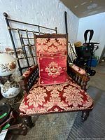 Front view of armchair with pillow showing overall design and condition