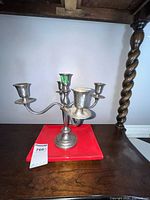 Front view of silver plated 5-arm candelabra on table