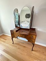Full view of vintage walnut vanity with tri-fold mirrors