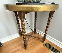 Full view of table showing brass top and barley twist legs