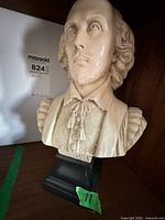 Front view of cream resin bust of William Shakespeare on black base