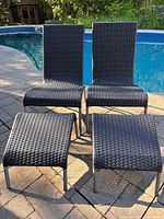 Full view of two lounge chairs and two ottomans poolside