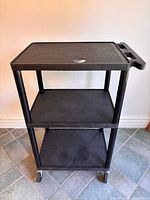 Front view of the three-tier Apollo utility cart showing overall structure and casters