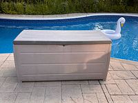 Closed deck box front view beside pool