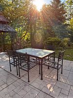 Full view of table and six chairs on patio