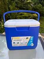 Front of blue Coleman Excursion cooler with label visible