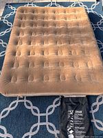 Top view of queen inflatable mattress showing flocked surface