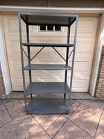 Full front view of metal shelving unit standing outdoors