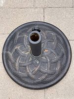 Top view of resin umbrella base showing basketweave pattern and central collar