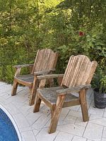 Both wooden Adirondack chairs beside pool
