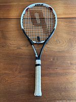 Full view of Prince Air O 107 racket showing overall design and worn grip