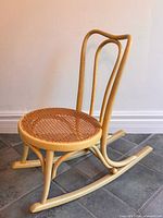 Full view of child bentwood rocking chair front angle, shows overall design and condition