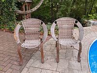 Front view of both wicker hoop chairs beside pool