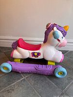 Side view of VTech unicorn on rocking base with wheels