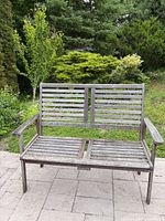 Front view of entire slatted wooden bench