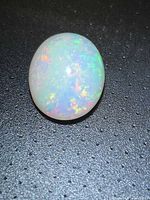 Top view of oval opal showing full play of colour