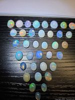 Full layout of opal cabochons arranged in rows