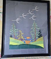 Full view of framed needlepoint wall art